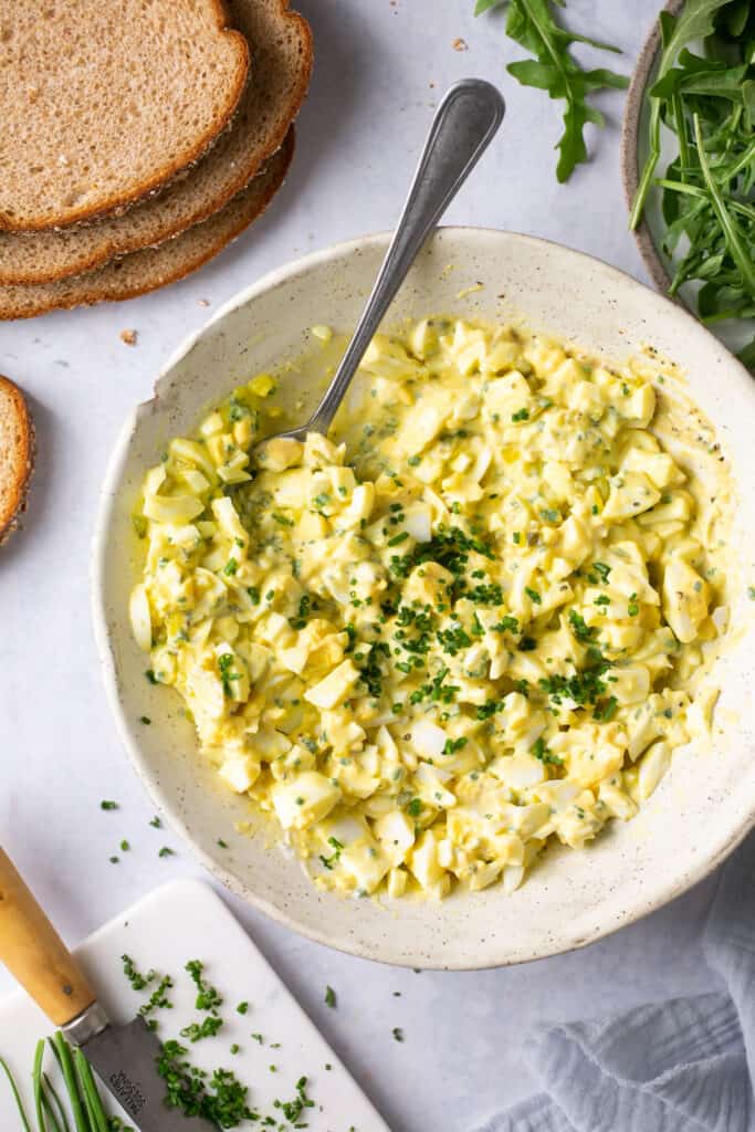 Low calorie egg salad in a bowl with a spoon.