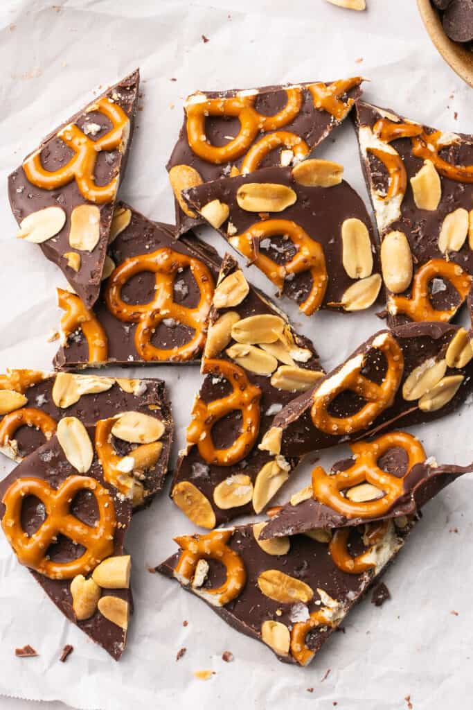 Zoomed in view of dark chocolate pretzel bark brokjen into pieces. 