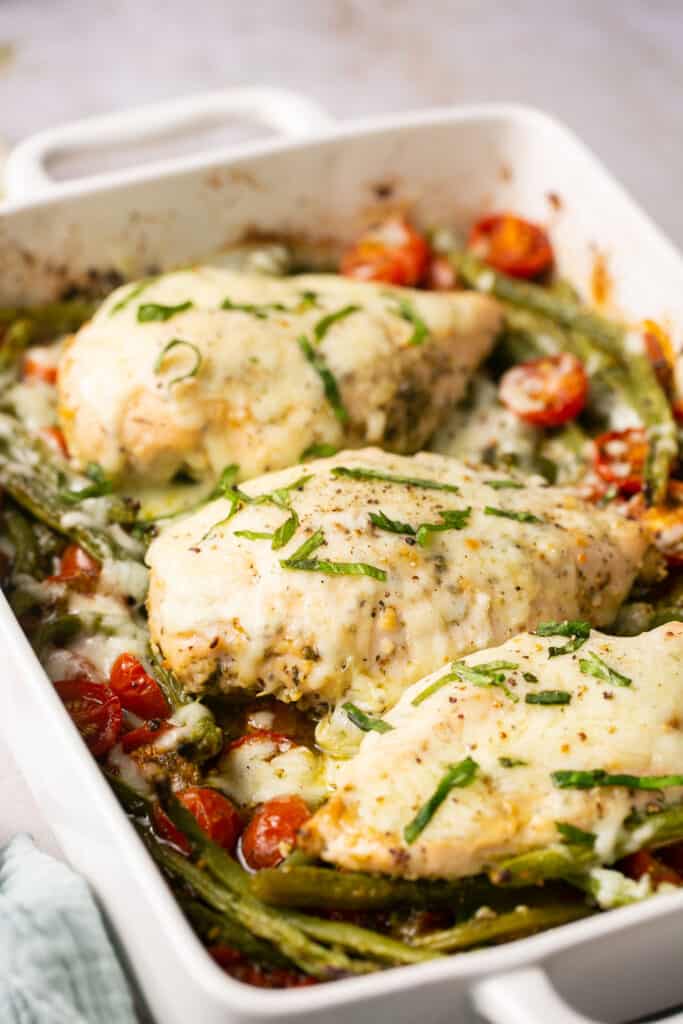 Baked chicken pesto recipe in a baking dish.