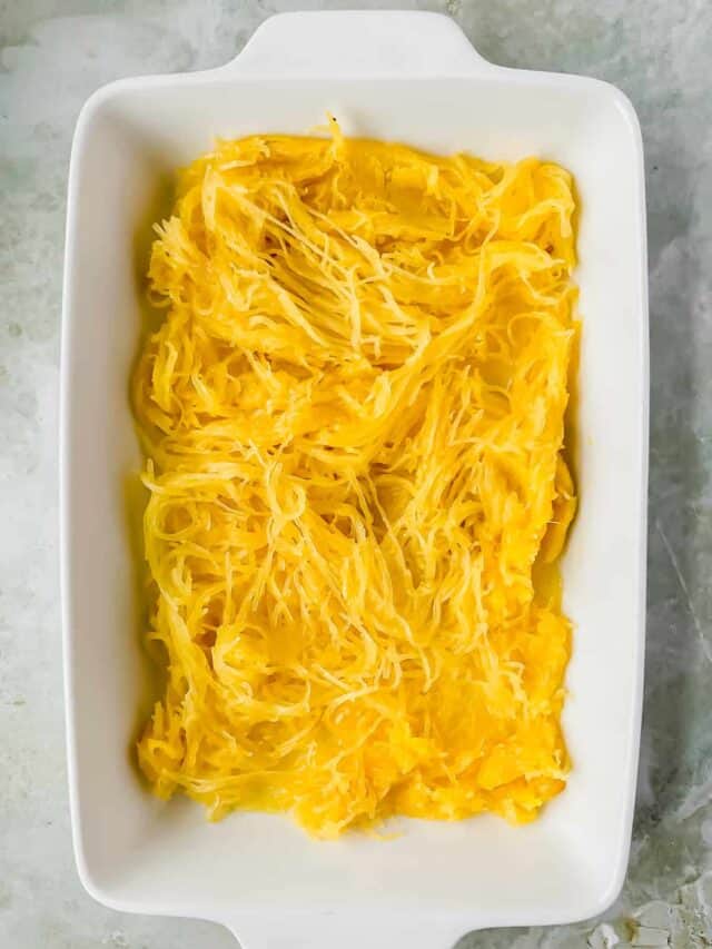 Cooked spaghetti squash in a baking dish.