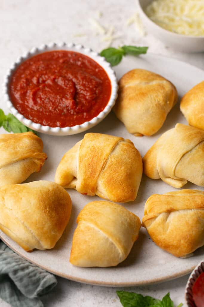 3 ingredient air fryer pizza puffs on a plate with marinara sauce.