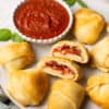3 ingredient air fryer pizza puffs on a plate with marinara sauce.