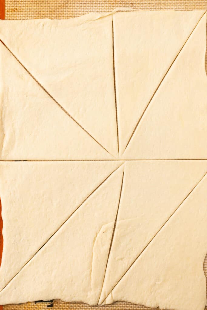 Dough sheet cut into triangles.