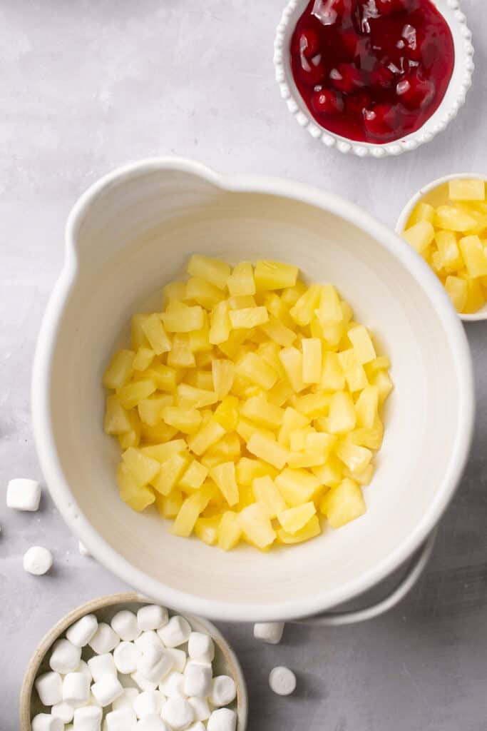 Cut up pineapple in a mixing bowl.