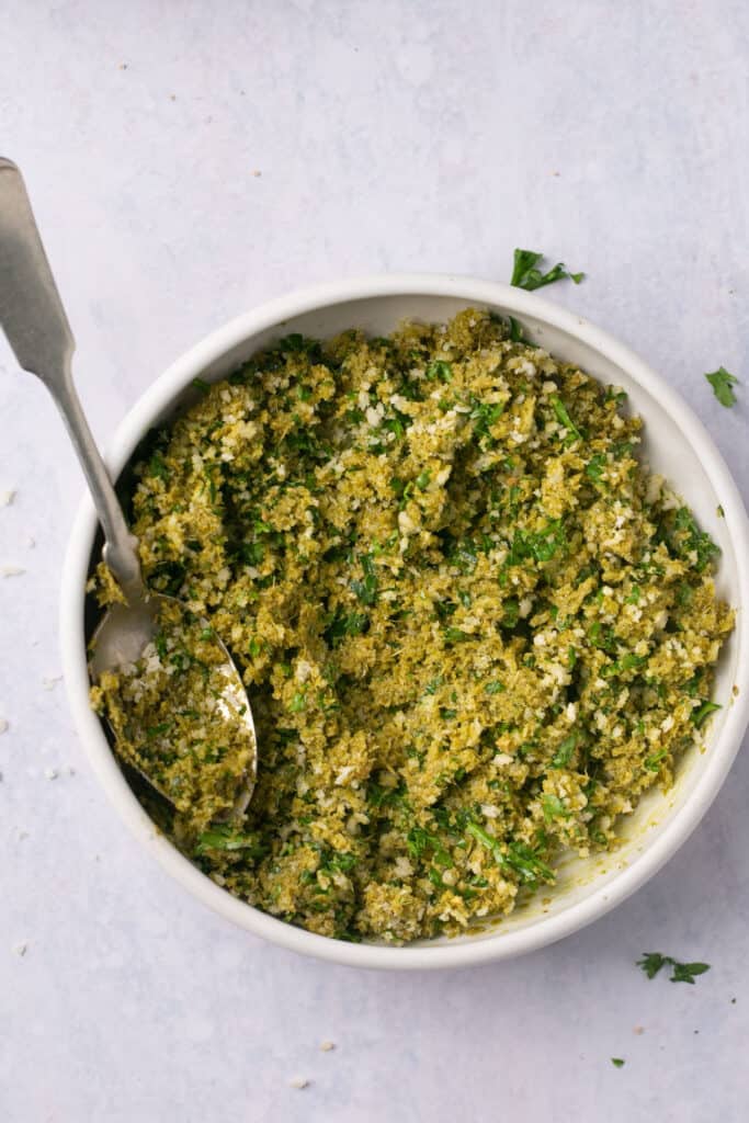 Pesto mixture in a bowl with a spoon