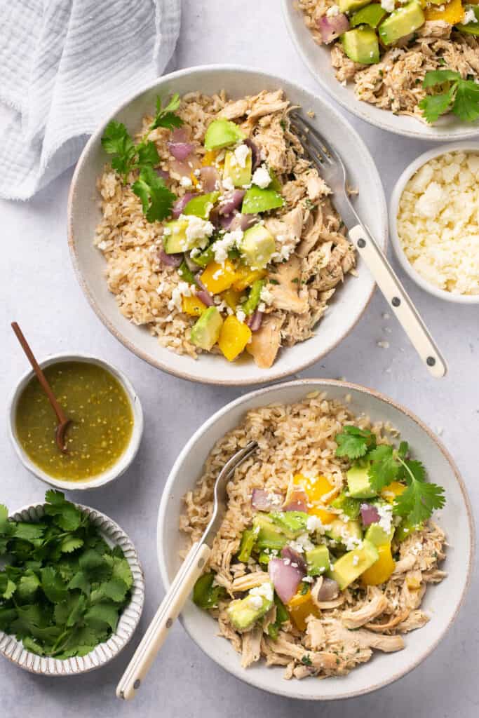 Salsa verde chicken bowls with forks.