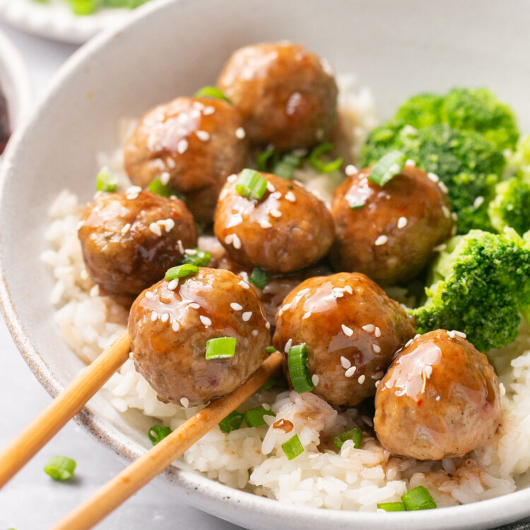3 ingredient meatballs with rice and broccolli in a bowl with chopsticks.