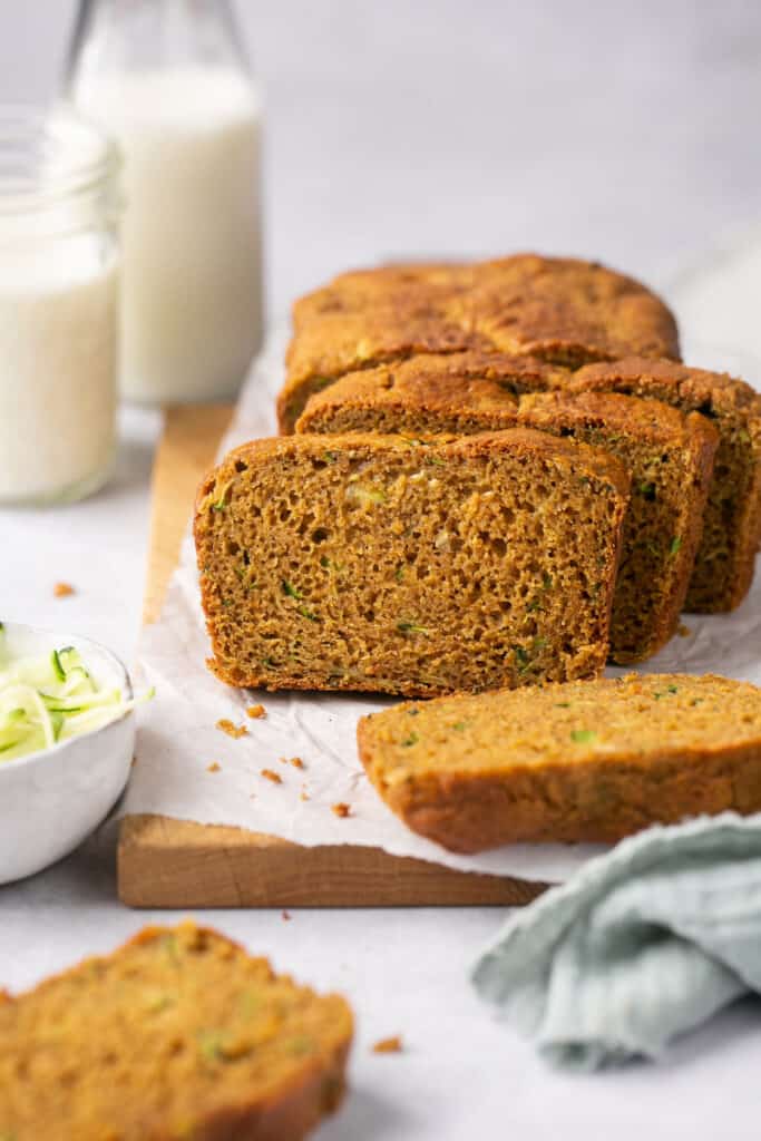 Sliced healthy gingerbread zucchini bread on parchment paper.