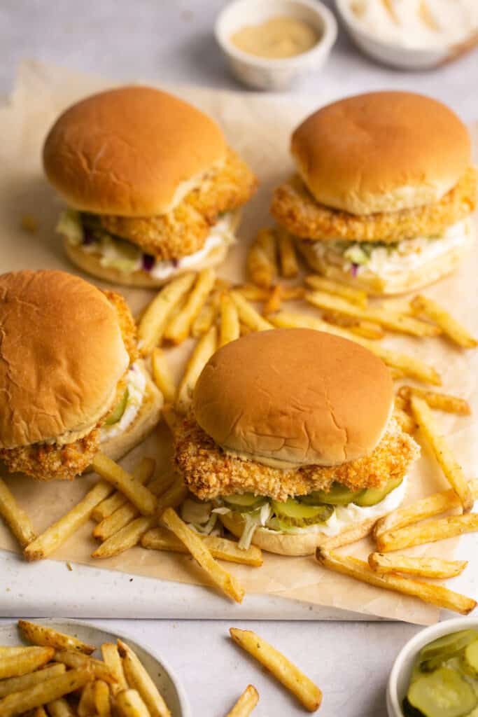 Air Fryer chicken sandwiches on a cutting baord with french fries