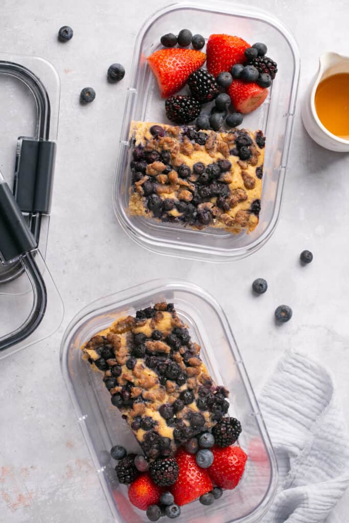 Sausage pancake breakfast bake in meal prep containers with berries.