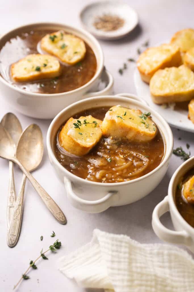 Healthy french onion soup recipe topped with cheesy baguette in a bowl