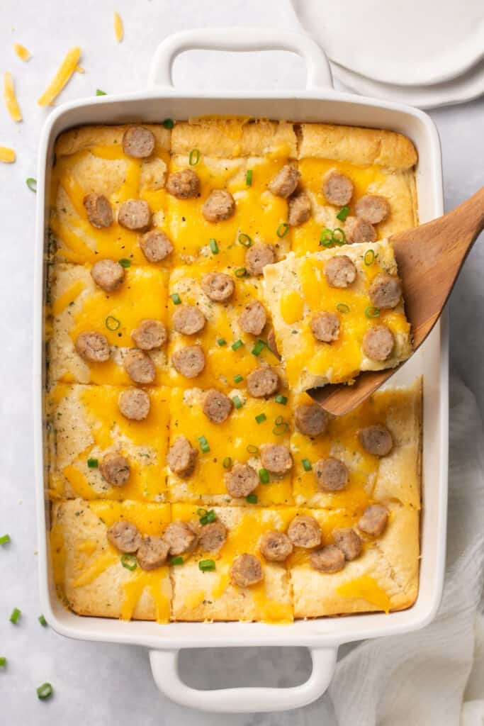 Cheddar Chicken Sausage Crescent Roll Breakfast Pizza in a baking dish cut into servings