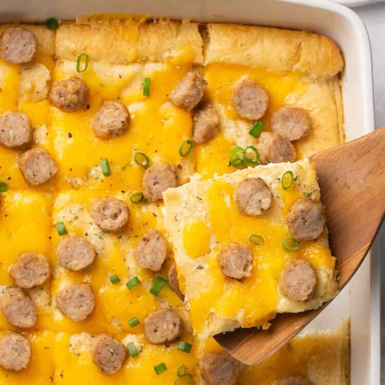 Cheddar Chicken Sausage Crescent Roll Breakfast Pizza in a baking dish cut into servings.