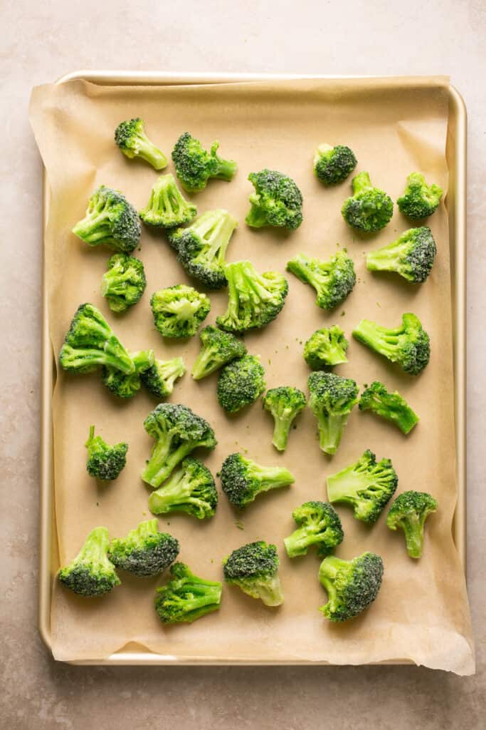 Cut up broccolli on a baking sheet with parchment paper.