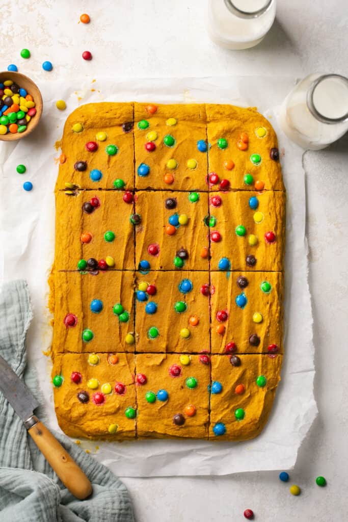 Soft Baked M&M Pumpkin Protein Oat Bars on parchment paper.