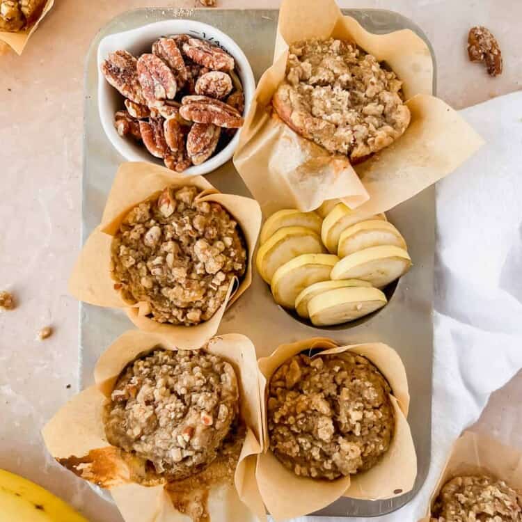 Banana nut protein muffins with pecan crumble on a tray.