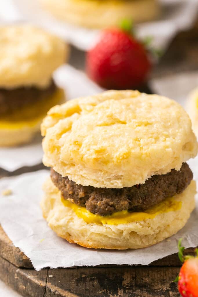 Healthy Sausage Biscuits on a wooden cutting board with parchment paper 