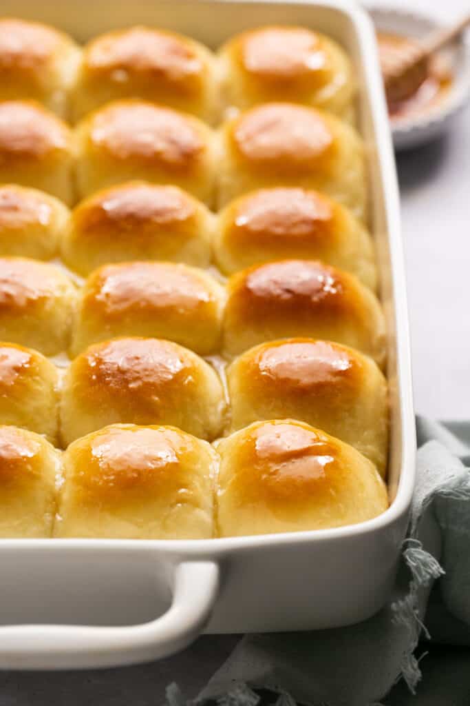 Honey butter yeast rolls in a baking dish after being baked.