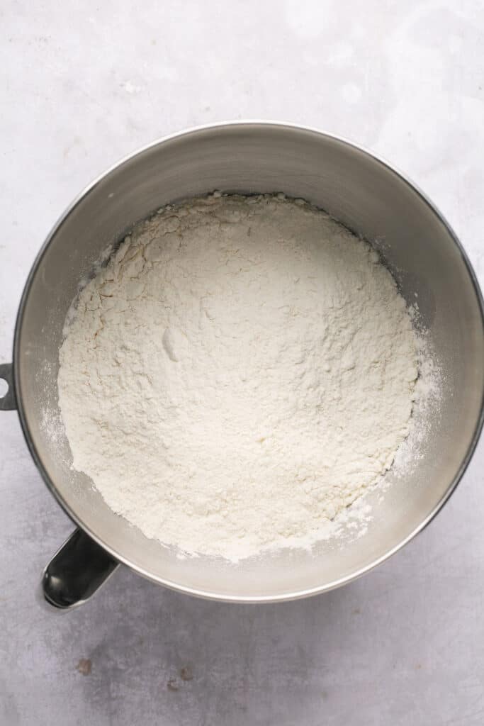 Flour being mixed into the other ingredients in a mixing bowl.