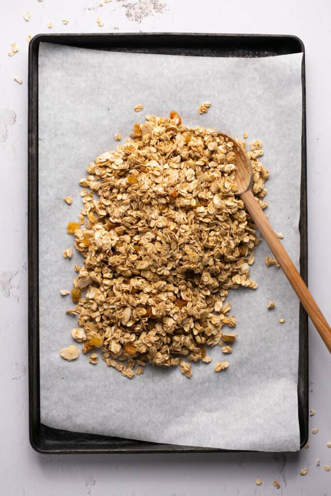 Honey Almond Granola recipe on a baking sheet with parchment paper before being baked.