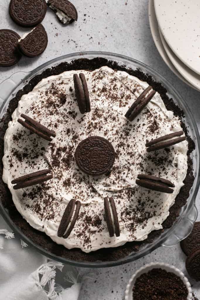 No bake oreo pie topped in a pie dish topped with addtional Oreos.