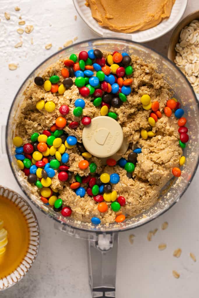 M&Ms being folded in the dough inside the food processor.