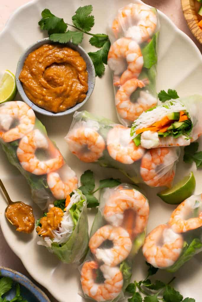 Vietnamese Summer Rice Paper Rolls with Peanut Dipping Sauce on a large plate.