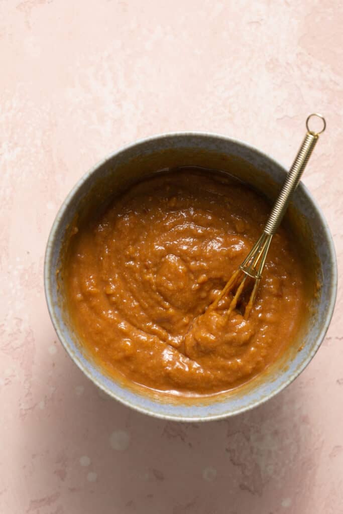 Ingredients for peanut sauce in a small bowl with a whisk.