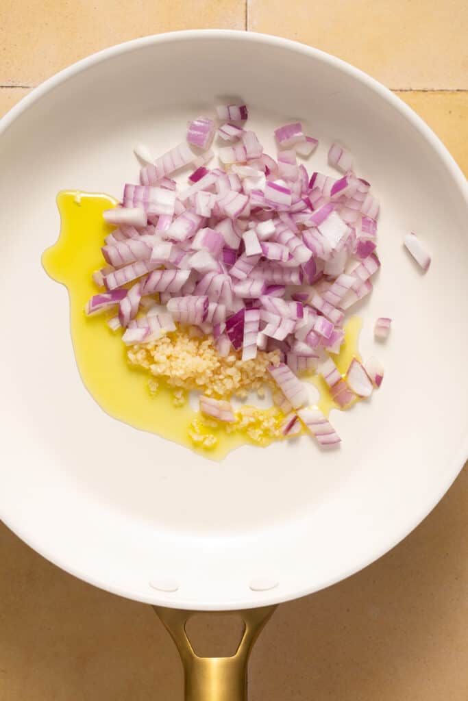 Red onion and olive oil in a skillet.
