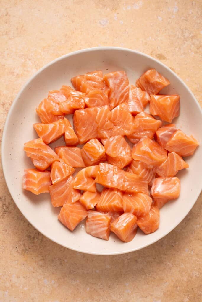 Pieces of raw salmon on a plate.
