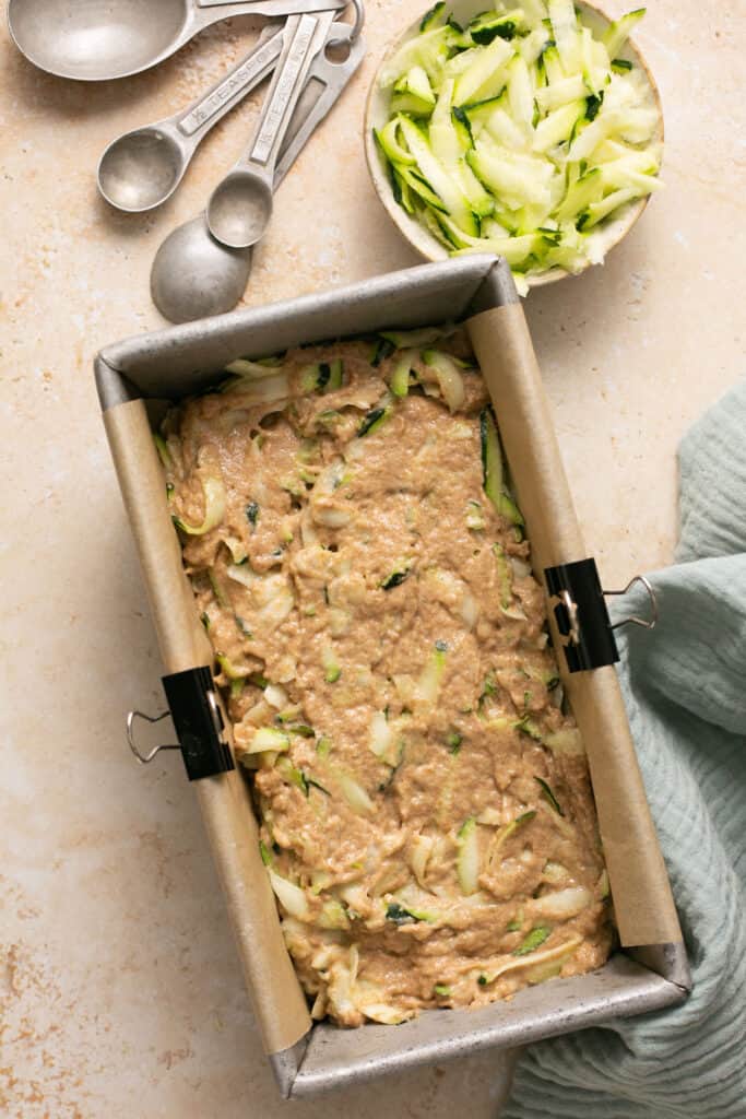 Batter for healthy zucchini bread in a loaf pan before being baked.