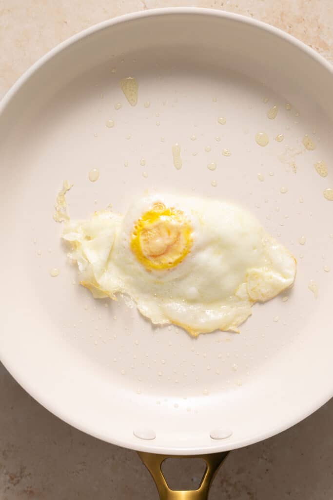 A cooked egg in a skillet.