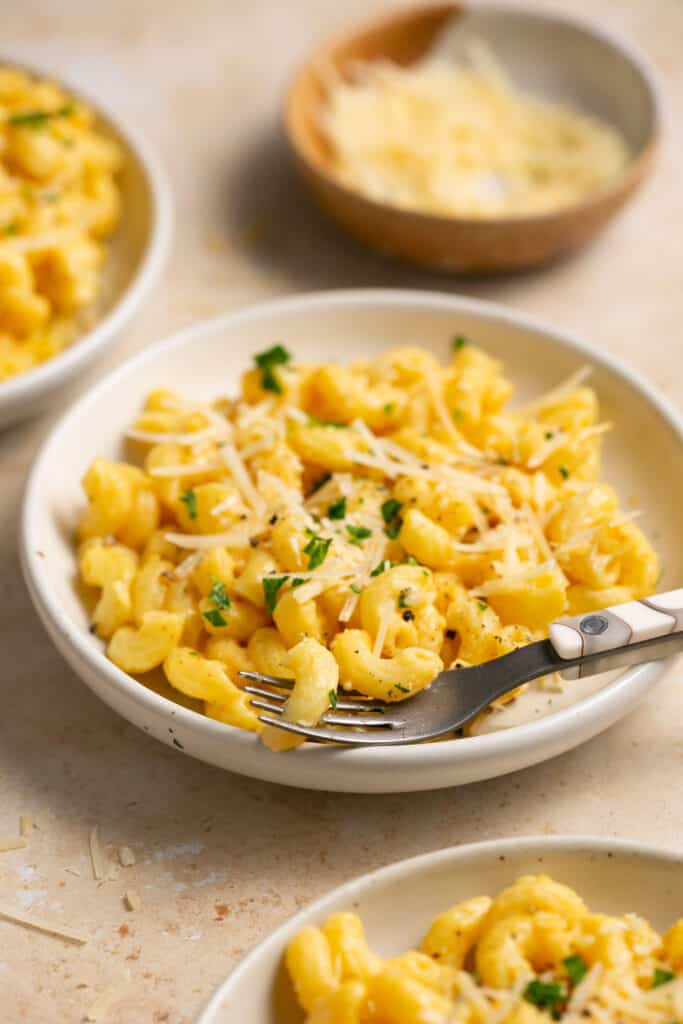 Cottage cheese mac and cheese on a plate with a fork.