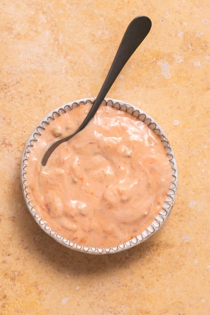 Salsa yogurt dressing in a bowl with a fork.