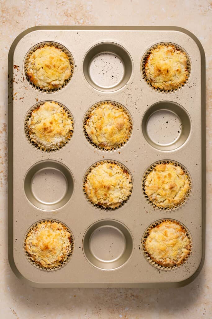 Low carb lemon poppy seed muffins in a muffin pan after being baked.