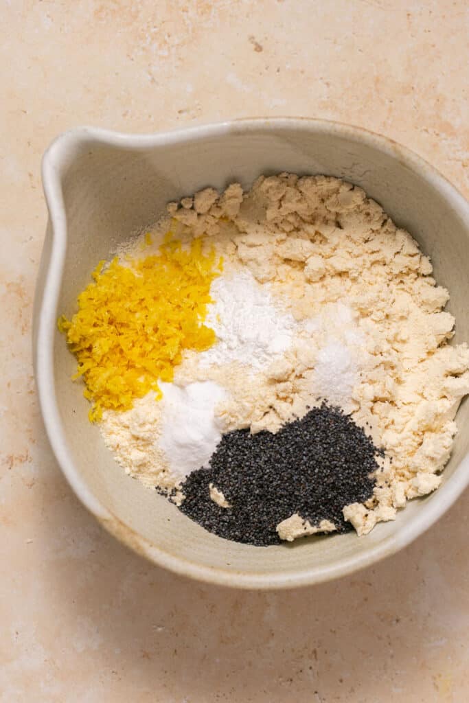 Dry ingredients for low carb lemon poppy seed muffins in a mixing bowl before being mixed together.
