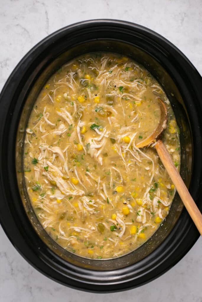 Healthy Crockpot White Chicken Chili in a slow cooker.