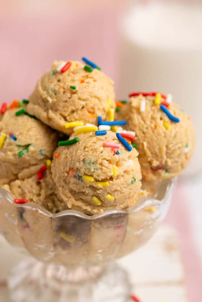 Zoomed in view of Funfetti protein cookie dough in a glass bowl.