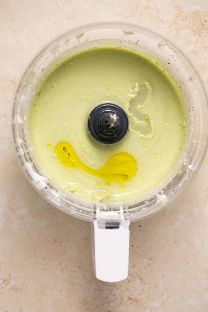 Ingredients for avocado lime ranch dressing in a food processor.