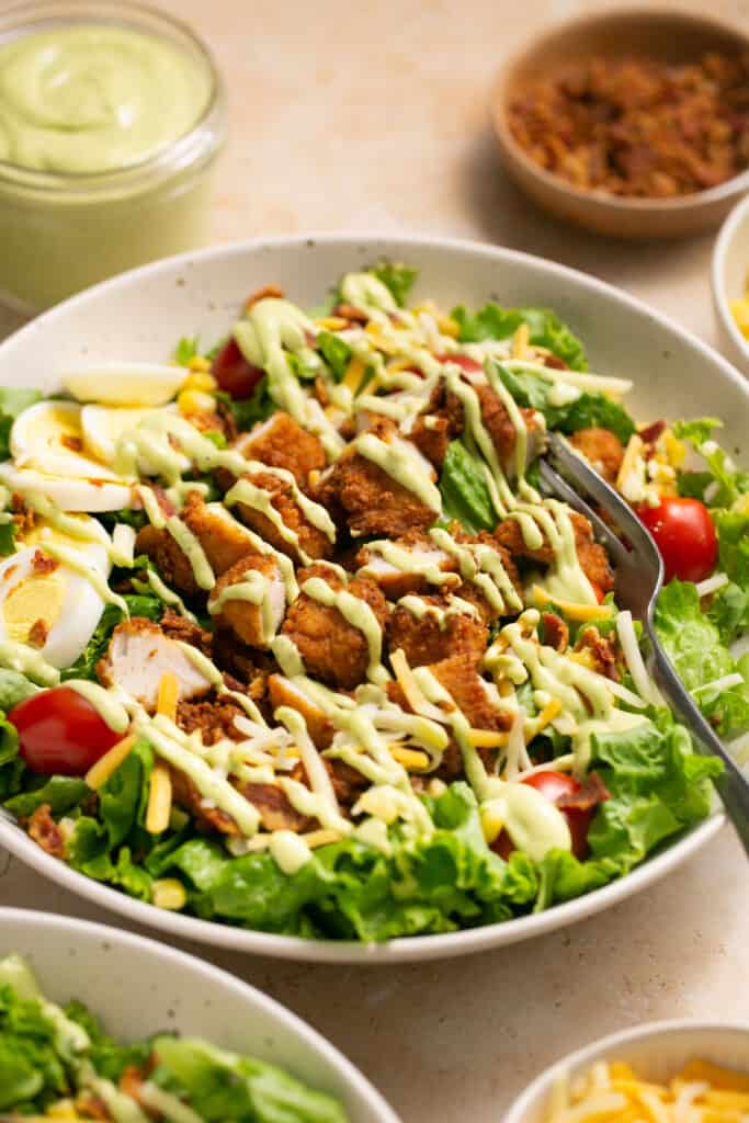 Chick-fil-a cobb salad recipe in a bowl topped with dressing.
