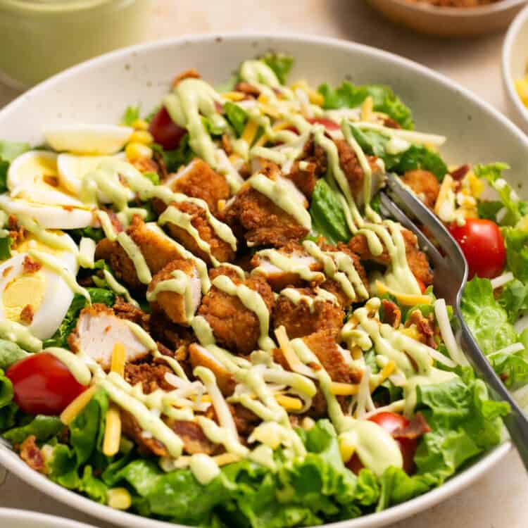 Chick-fil-a cobb salad recipe in a bowl topped with dressing.