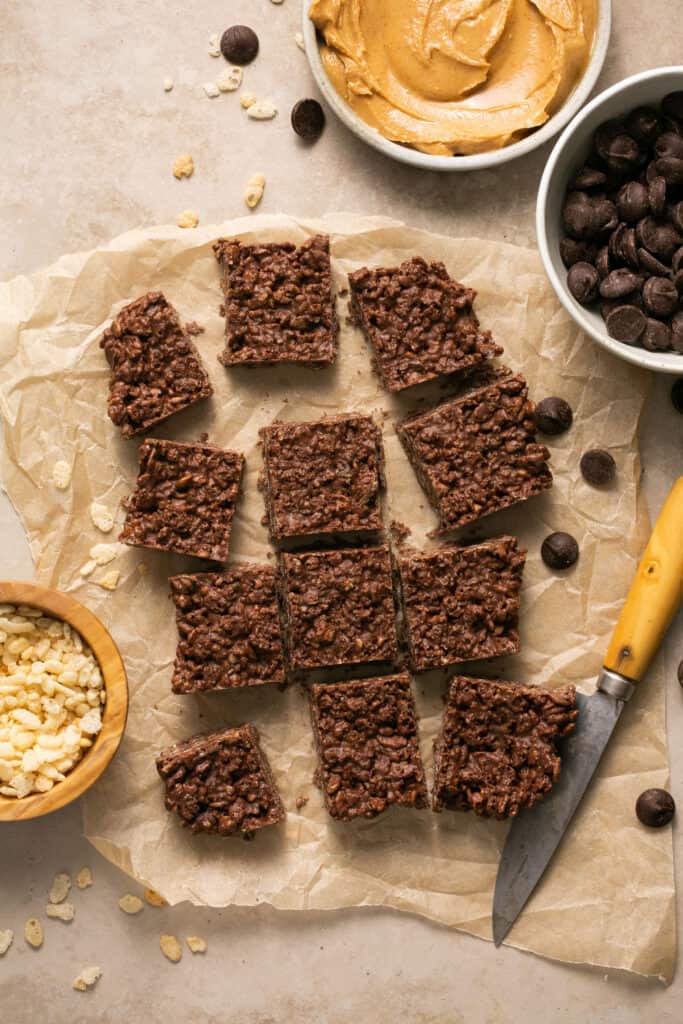 Chocolate peanut butter crunch bars on parchment paper.