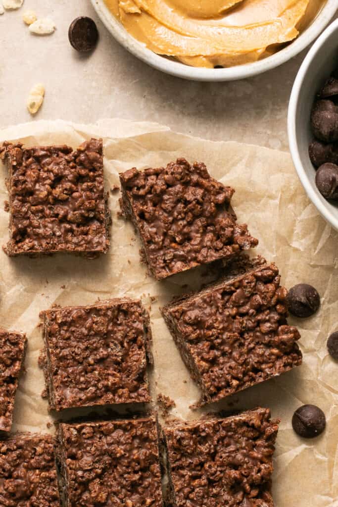Chocolate peanut butter crunch bars on parchment paper.
