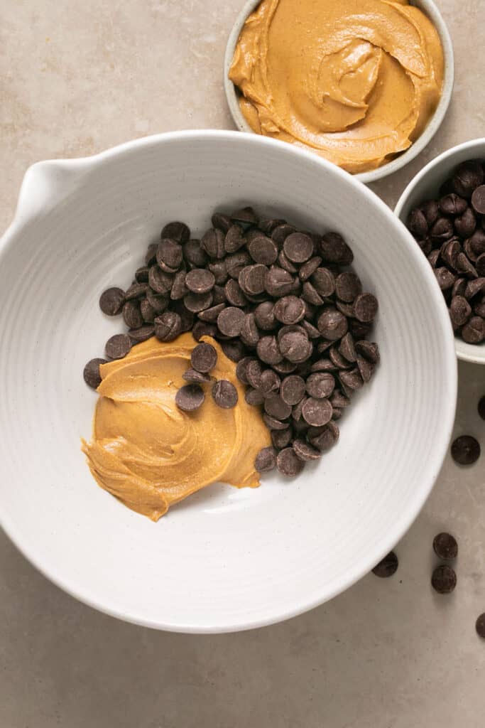Chocolate chips and peanut butter in a mixing bowl.