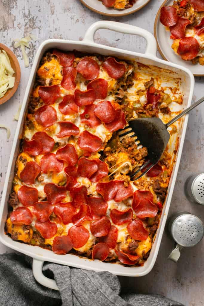 Pizza casserole with biscuits in a baking dish.