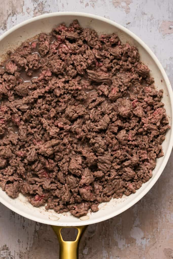Cooked ground beef in a skillet.