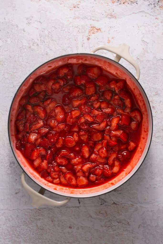 Cooked strawberry mixture in a saucepan.