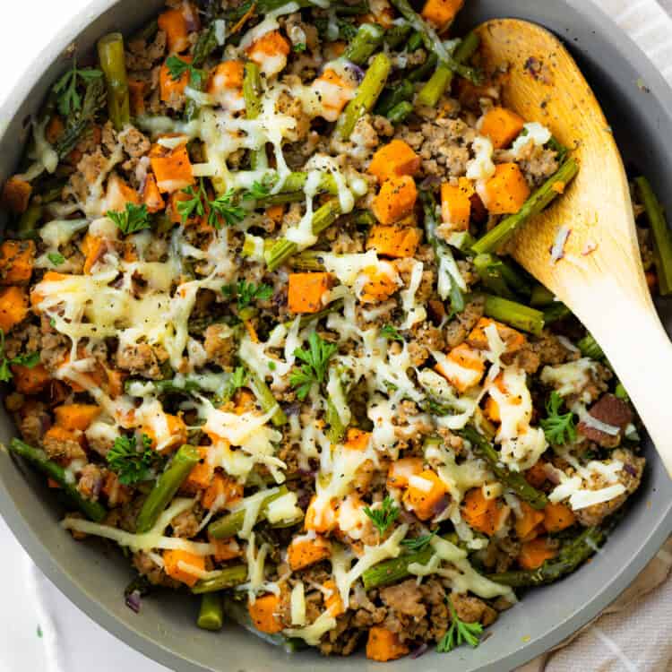 Simple sweet potato and ground turkey skillet with a wooden spoon.