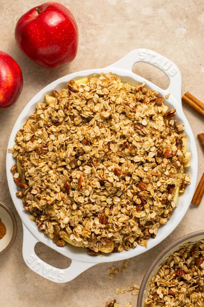 Healthy apple pecan crisp in a baking dish before being baked.