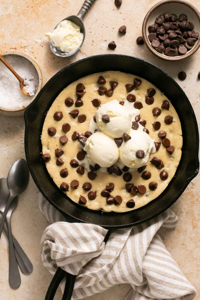 Protein skillet cookie topped with ice cream in a skillet.